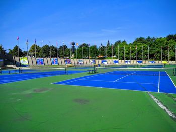 Scenic view of soccer field against blue sky