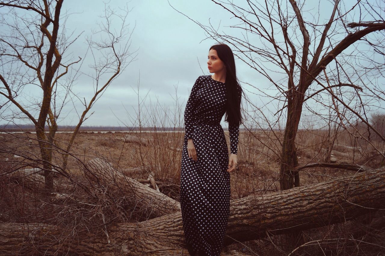 lifestyles, casual clothing, young adult, person, bare tree, leisure activity, standing, tree, full length, sky, front view, looking at camera, portrait, young women, three quarter length, day, outdoors, nature