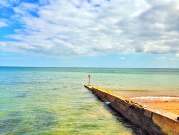 Scenic view of sea against cloudy sky