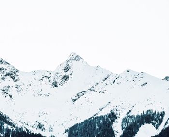 Aerial view of snowcapped mountain against clear sky