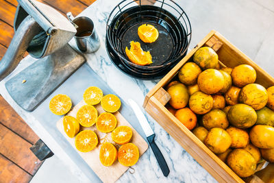 High angle view of fruits in crate by container on table