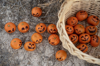 Healthy trick or treat snacks for kids on halloween--basket of mandarin oranges jack o lantern faces