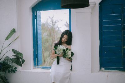 Woman standing by window