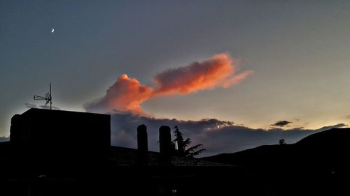 Low angle view of silhouette building against sky at sunset