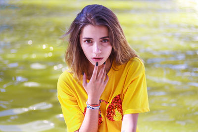 Woman posing against lake