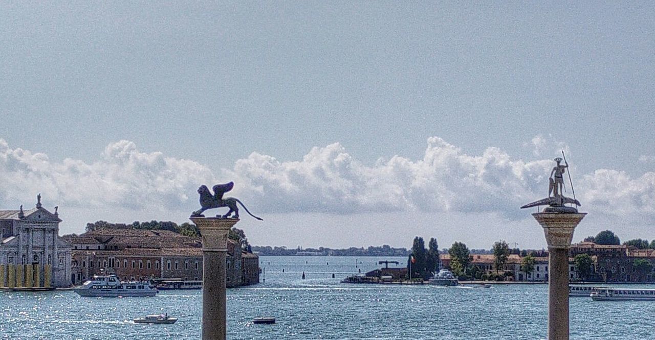 water, sea, building exterior, built structure, architecture, sky, nautical vessel, waterfront, sculpture, statue, human representation, railing, art and craft, day, outdoors, art, harbor, animal representation, city, river