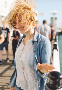 Smiling woman standing on pier