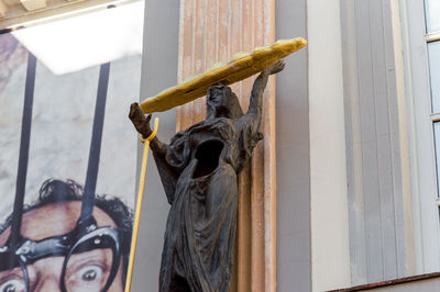 Low angle view of statue against wall