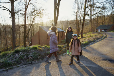 Rear view of girls walking on a country road