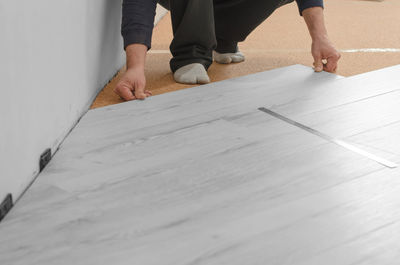 Low section of man standing on floor