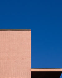 Low angle view of building against clear blue sky