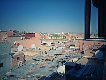 High angle view of buildings against clear blue sky