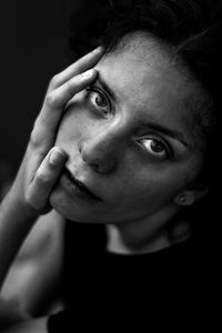 Close-up portrait of teenage girl over black background