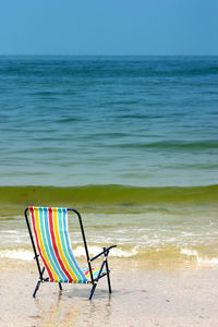 Multi colored empty chair on beach
