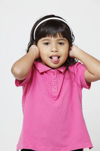 Portrait of smiling girl against gray background