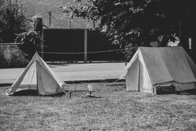 Tent on field by building