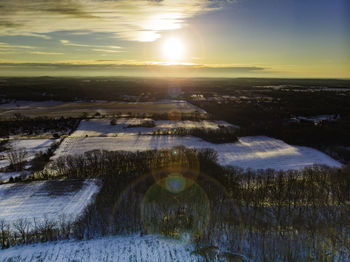 Scenic view of landscape against sky during winter