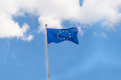 Eu flag waving on blue sky background with clouds