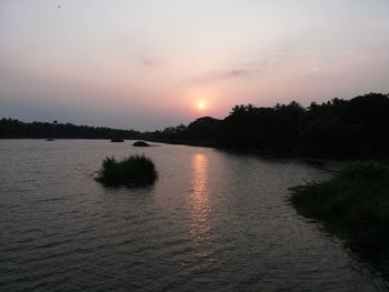 Scenic view of lake against sky during sunset