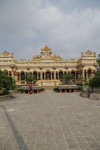 Facade of historic building against cloudy sky