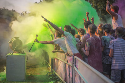 People celebrating holi with color spraying machine