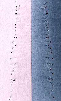 High angle view of needles on fabric