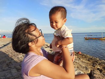 Friends on beach against sky