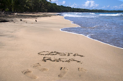 High angle view of text on sand at beach