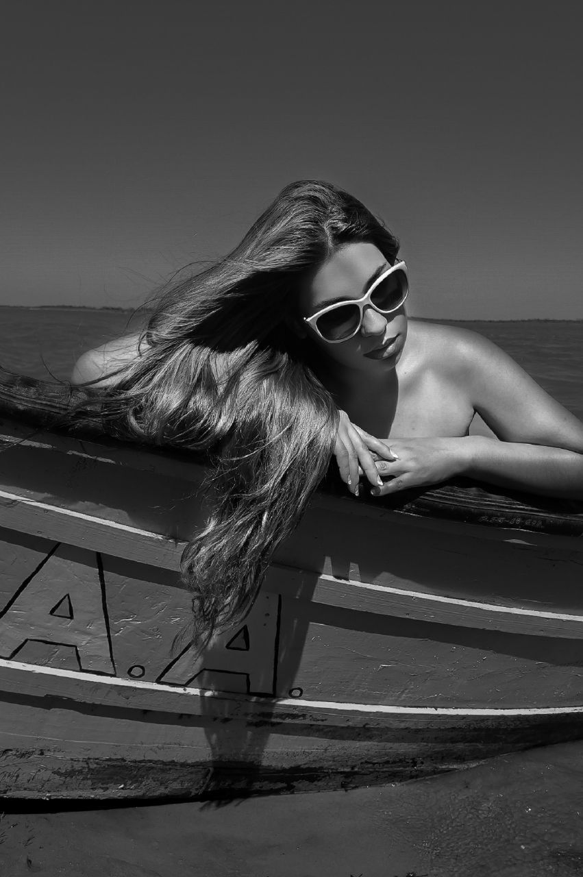 white, black, one person, black and white, adult, women, fashion, monochrome, young adult, monochrome photography, sunglasses, long hair, glasses, sitting, hairstyle, photo shoot, nature, lifestyles, leisure activity, relaxation, full length, water, sky, sea, female, portrait, land, person, darkness, clothing, beach, outdoors, day, swimwear