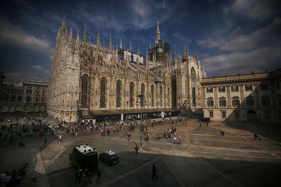 People at town square with duomo di milano against sky