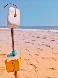 Lifeguard hut on beach against clear sky