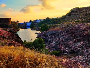 Scenic view of lake against sky during sunset