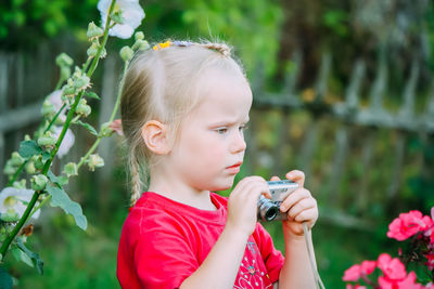 Portrait of young woman holding plant