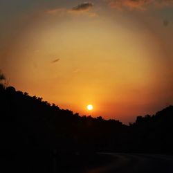 Scenic view of silhouette landscape against romantic sky at sunset