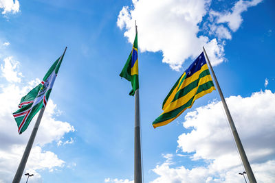 Low angle view of flags against sky