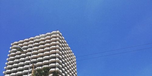Low angle view of building against clear blue sky