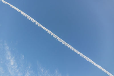 Blue sky and jet tail trail