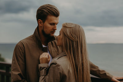 Love story of a young boy and girl. solitude with the sea one on one. baltic sea. sylt-ost, germany