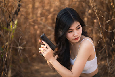 Young woman using mobile phone outdoors