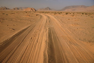 Tire tracks on sand in desert