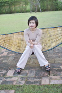 Portrait of young woman sitting on seat