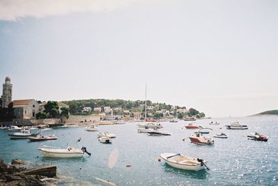 Boats in sea against clear sky