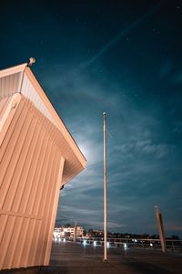 Low angle view of illuminated building against sky at night