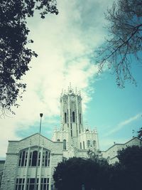 Low angle view of building against cloudy sky