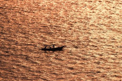 High angle view of boat sailing on sea during sunset