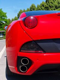 Close-up of red car on street