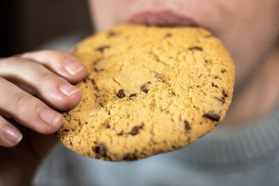 Close-up of woman eating cookie