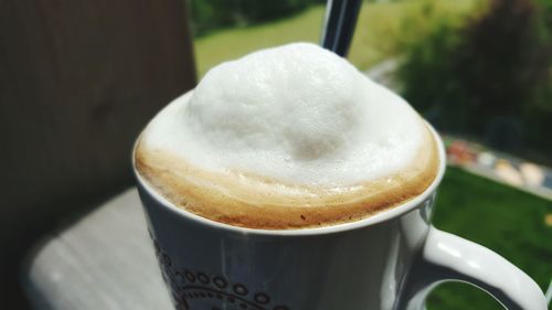 Close-up of coffee on window sill