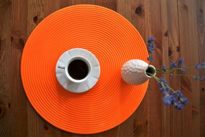 Directly above shot of coffee with flower vase on table