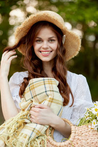 Portrait of young woman wearing hat